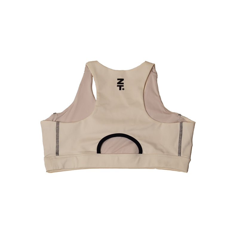 The CTRL Sports Bra in bone laid flat, back view, showing the racerback and open cut-out.