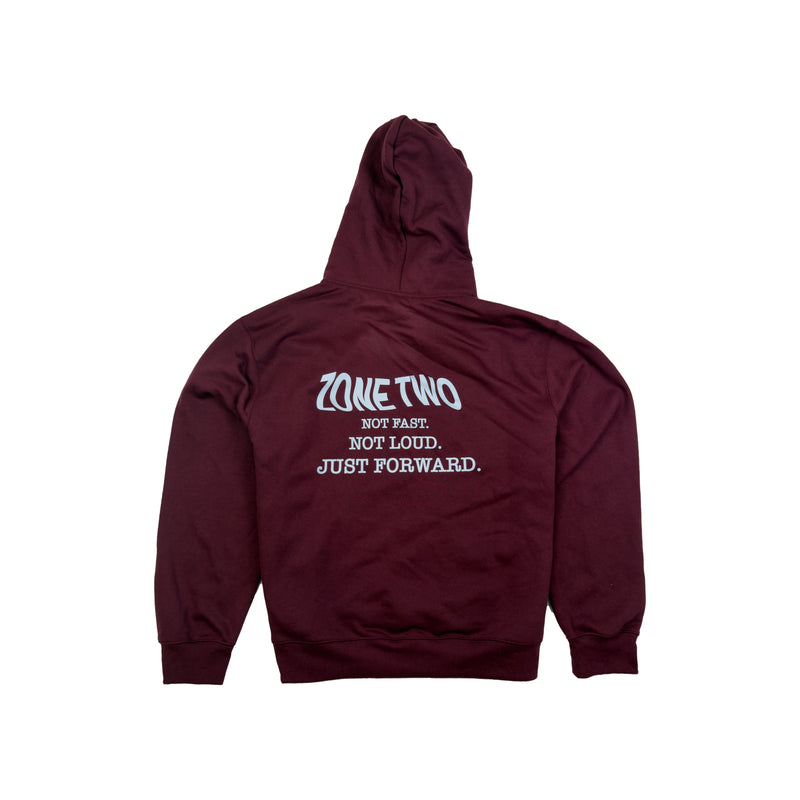 The burgundy Forward Hoodie laid flat, back view, with the ZONE TWO print.