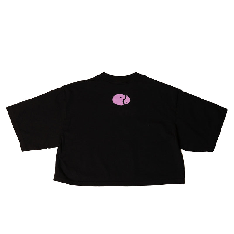 The Balance Crop laid flat in black, with a small pink oval mark at the left chest.