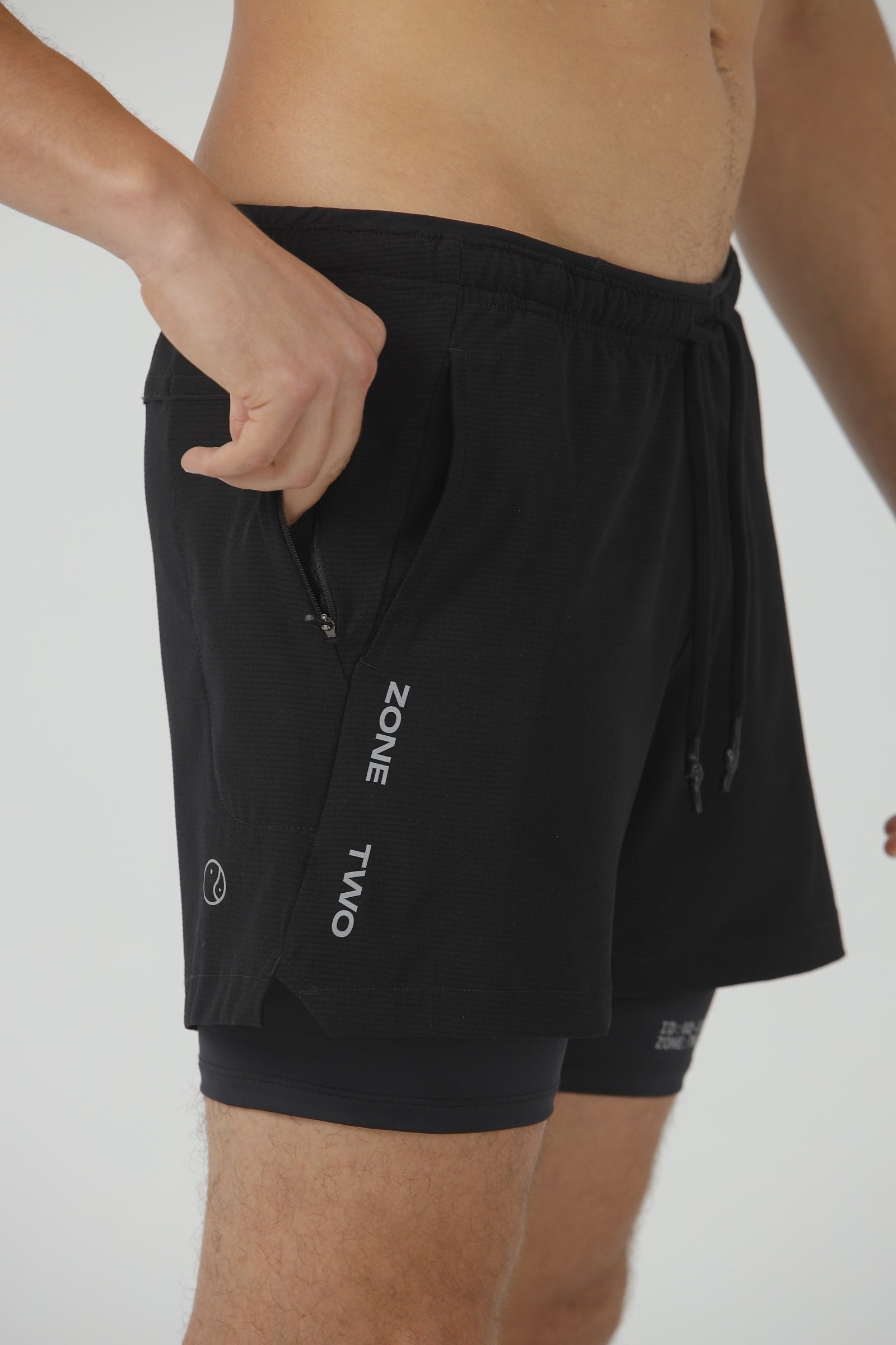 Close-up of the black Drift Shorts, showing the compressive inner liner below the outer shell.