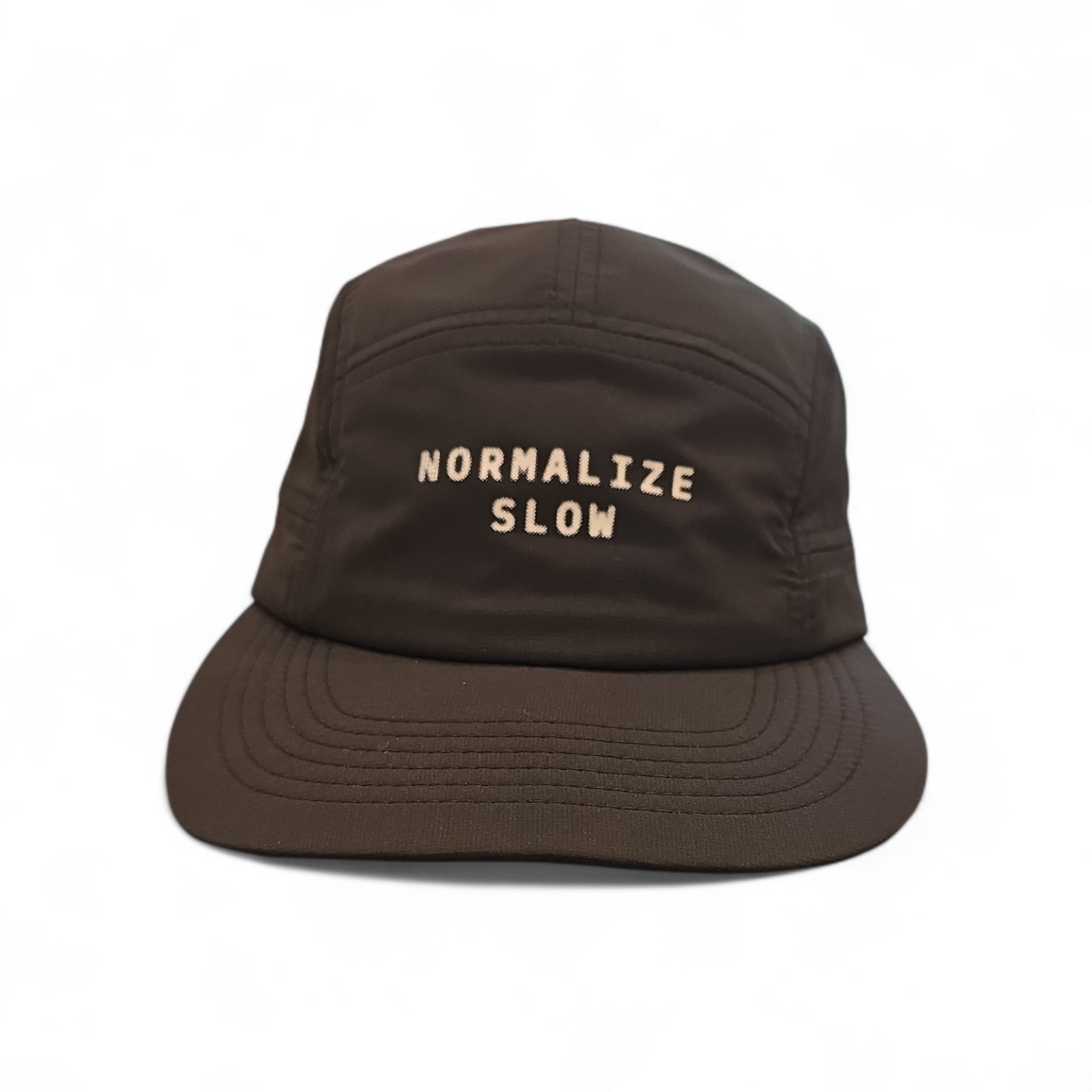 A five-panel cap in brown with NORMALIZE SLOW printed across the front panel.