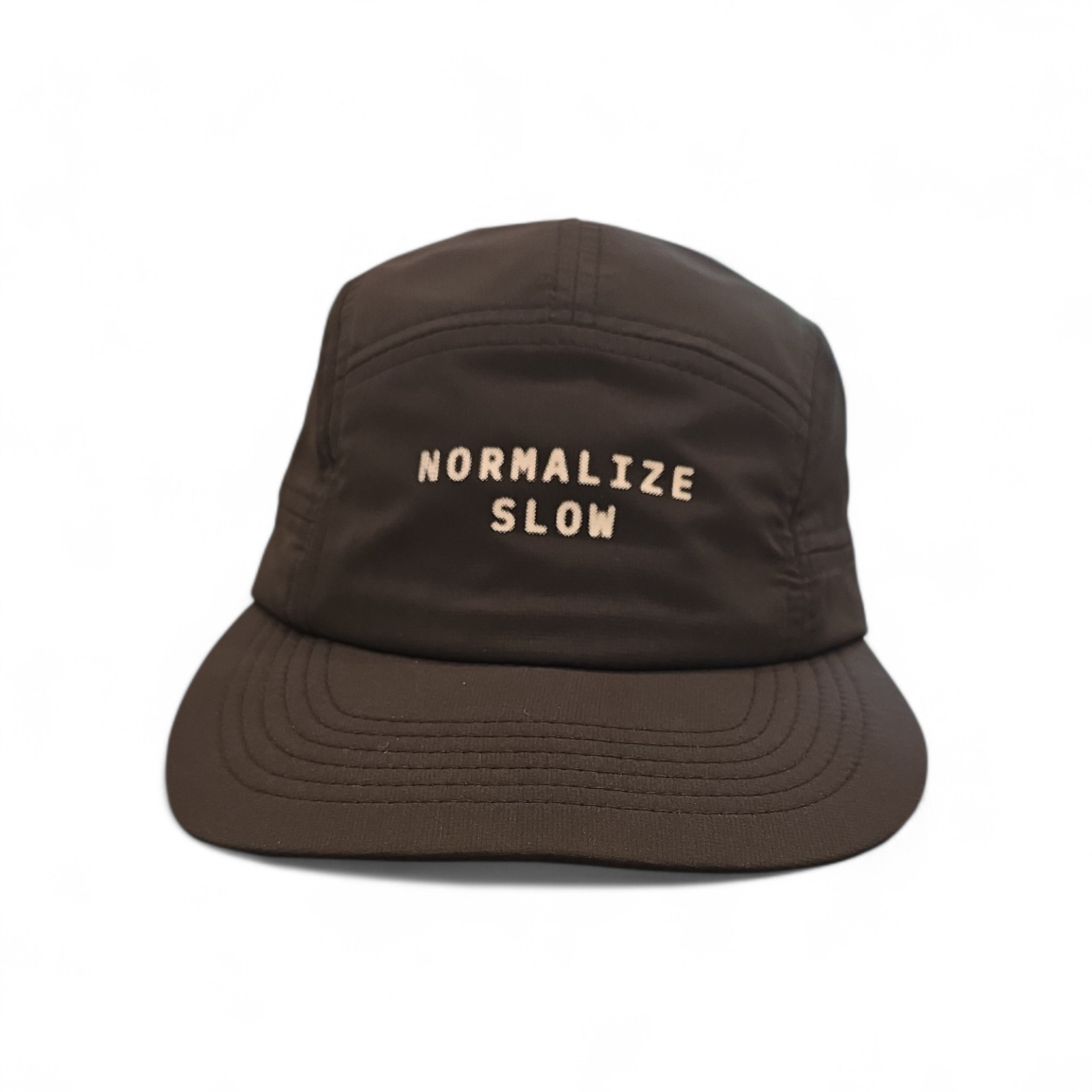 A five-panel cap in brown with NORMALIZE SLOW printed across the front panel.